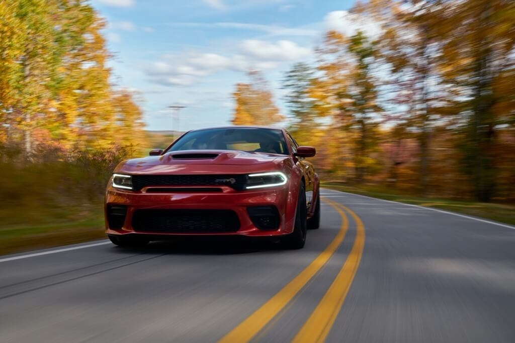 Front 3/4 view of the 2021 Dodge Charger on the road.
