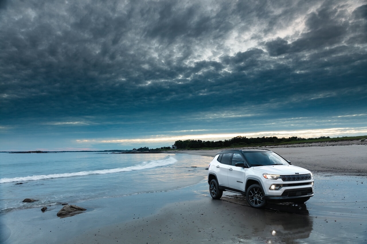 The 2022 Jeep Compass parked on a beach.