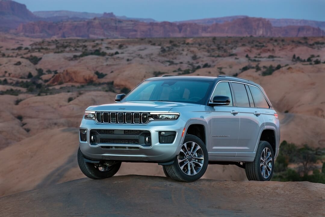 Front 3/4 view of the 2022 Jeep Grand Cherokee Overland parked in a desert.