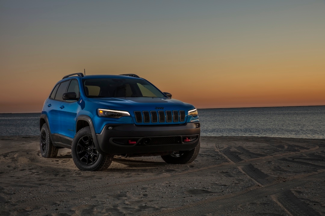 Front 3/4 view of the 2022 Jeep Cherokee Trailhawk parked on a beach.