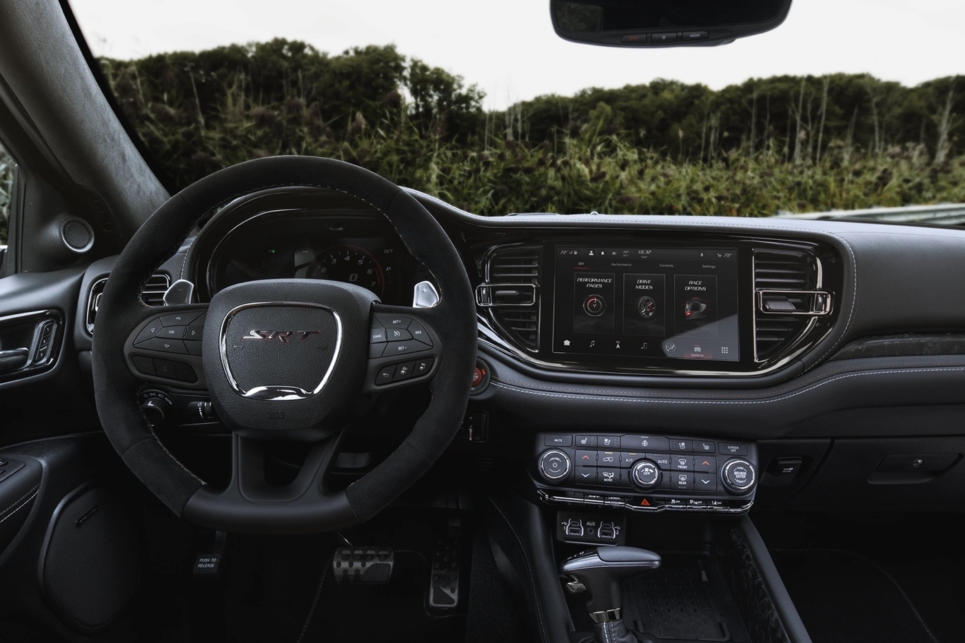 Interior view of the dashboard and steering wheel of the 2025 Dodge Durango SRT.