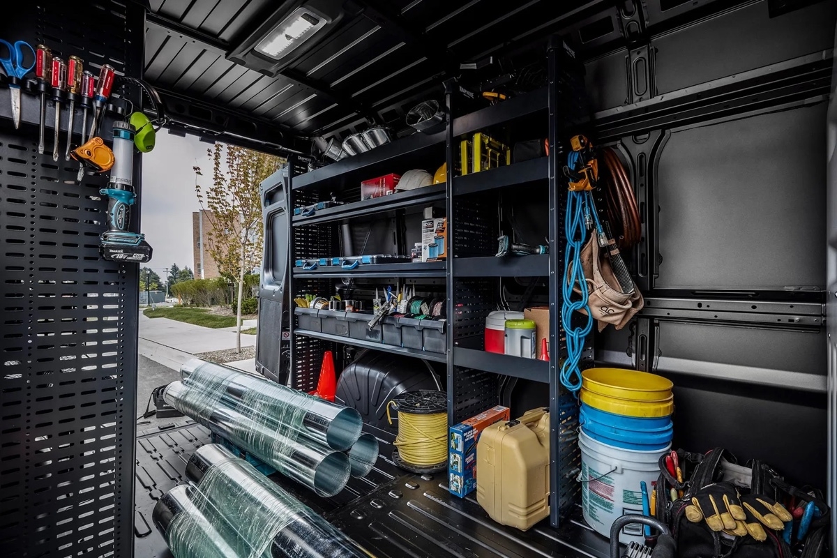 Cargo space of the 2026 Ram ProMaster fitted with shelves, tools, and materials, demonstrating the utility capacity and interior organization of the van.