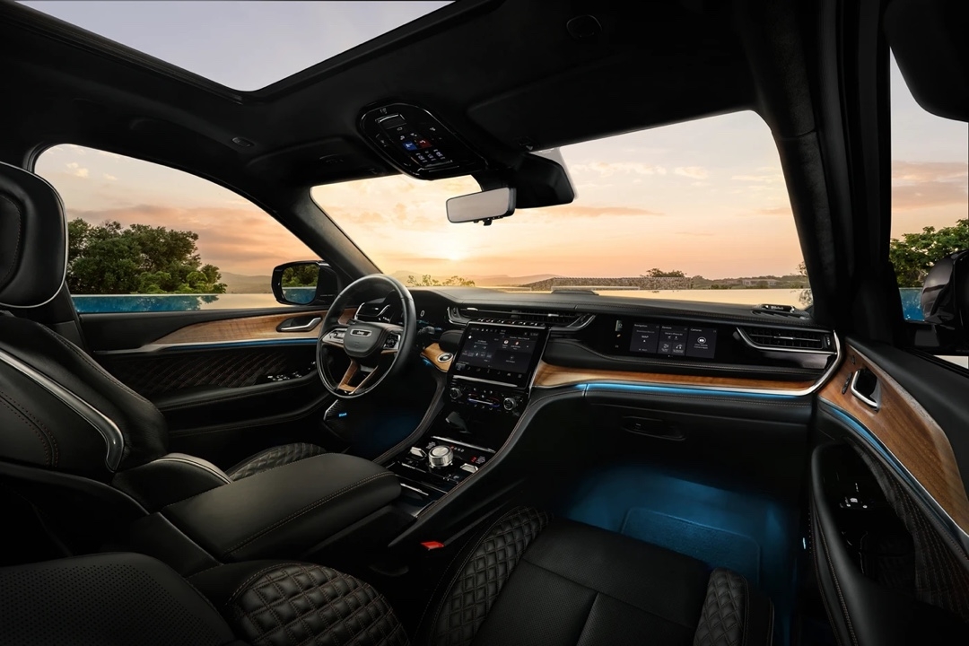 Luxurious interior of the 2025 Jeep Grand Cherokee 4xe with blue ambient lighting.