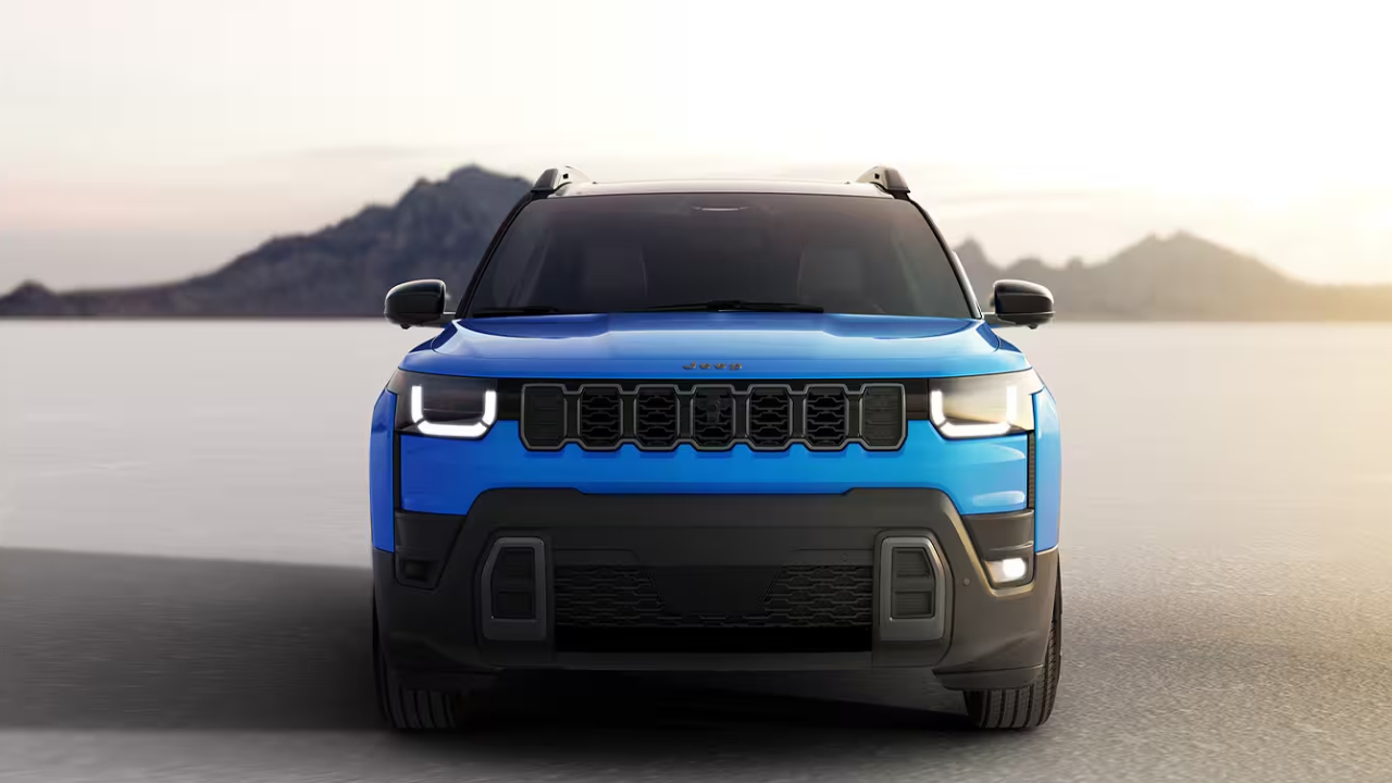 Vue avant du Jeep Cherokee 2026 bleu, mettant en valeur sa calandre emblématique et son style moderne.