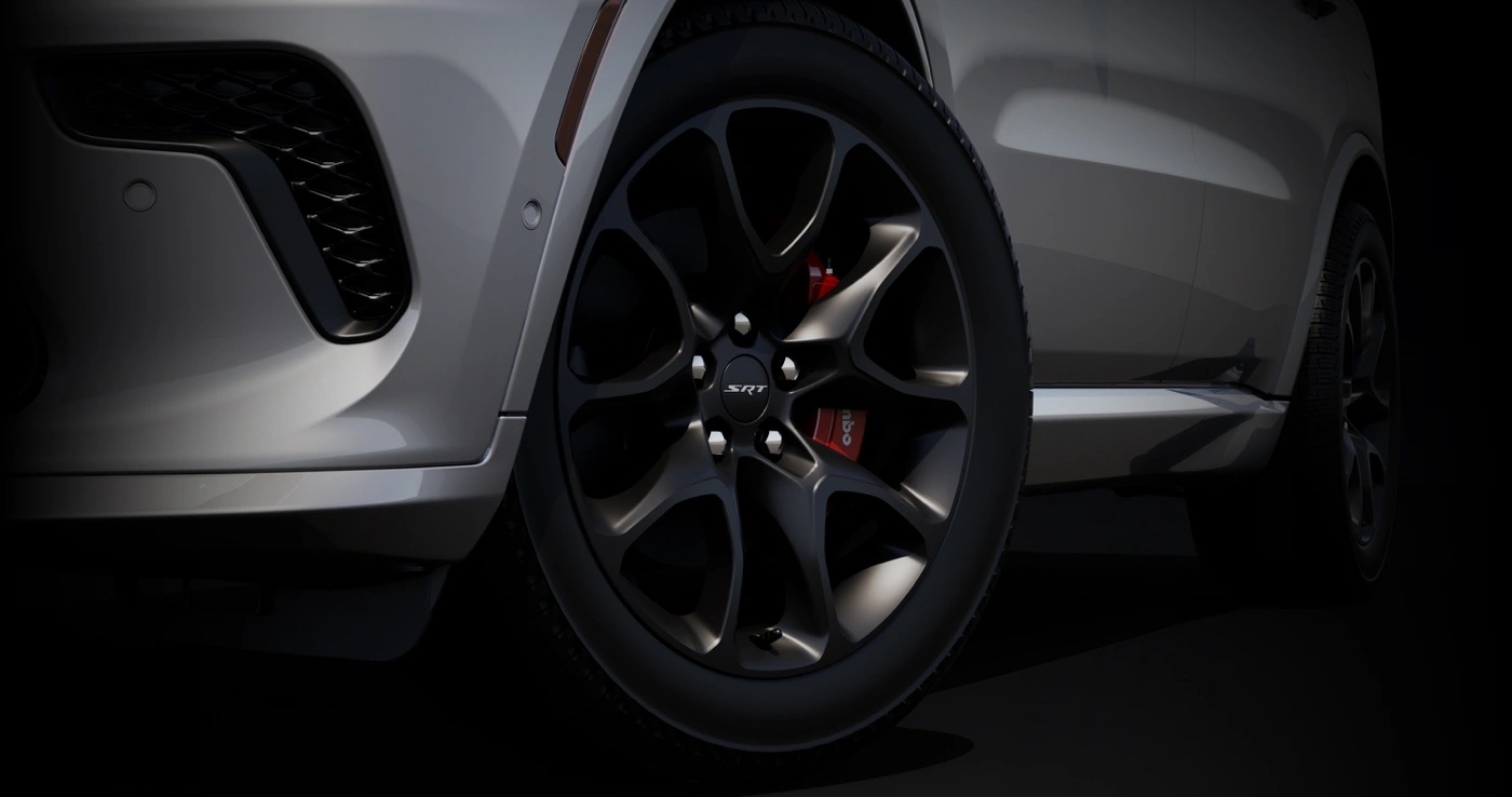 Close-up on the black SRT wheels of the 2025 Dodge Durango with red Brembo brakes.